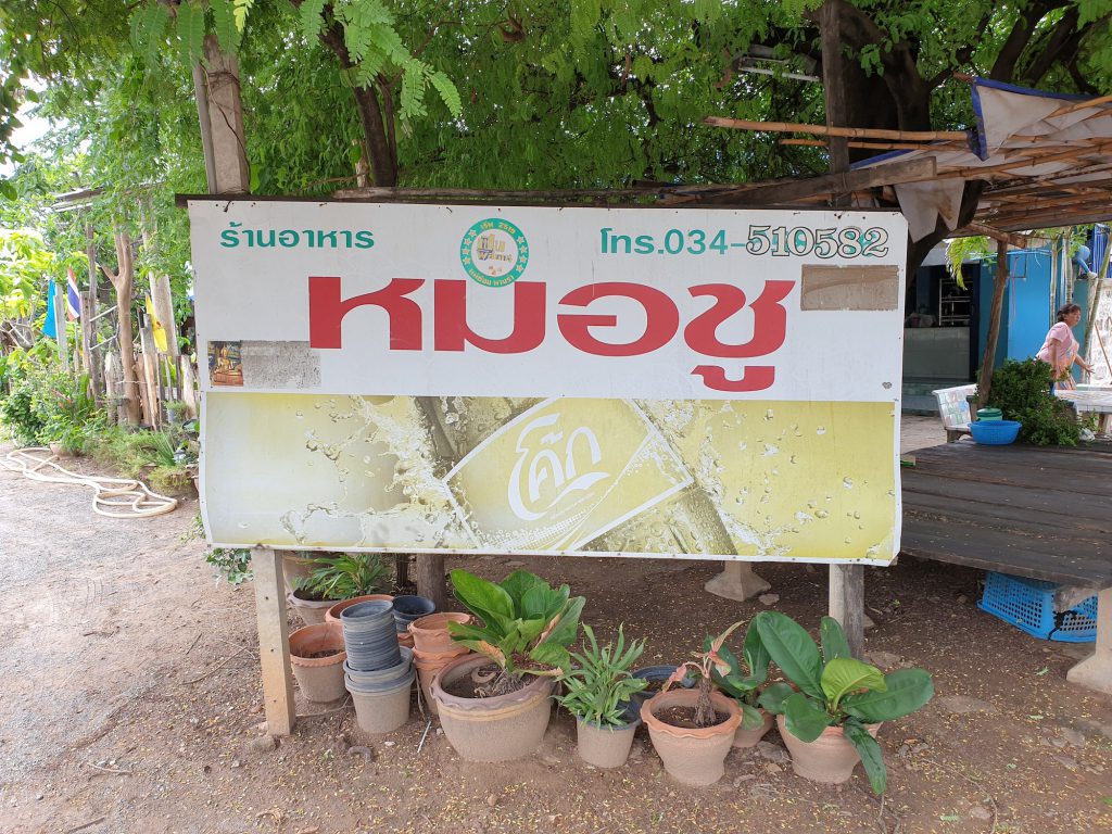 ป้ายร้านอาหารหมอชูพร้อมเบอร์โทรศัพท์ของร้าน